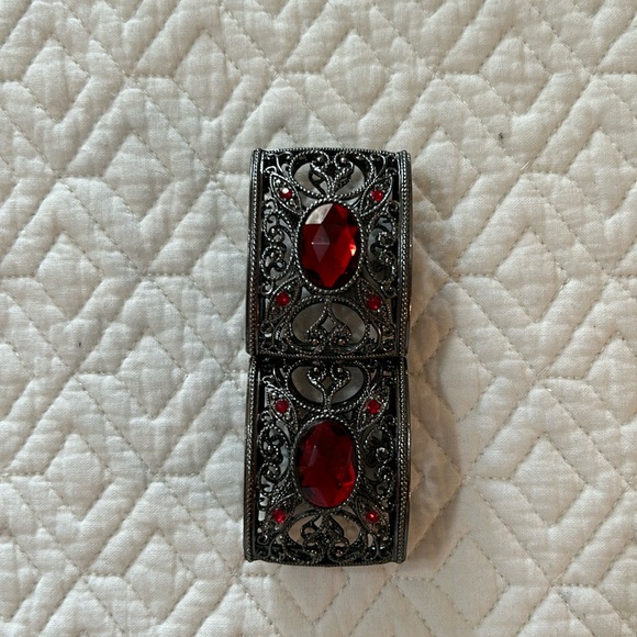 Gunmetal tone stretch bracelet with pretty scrollwork and red stones. - Picture 2 of 4